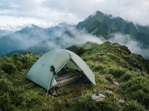 Spring trail tent on alpine meadow