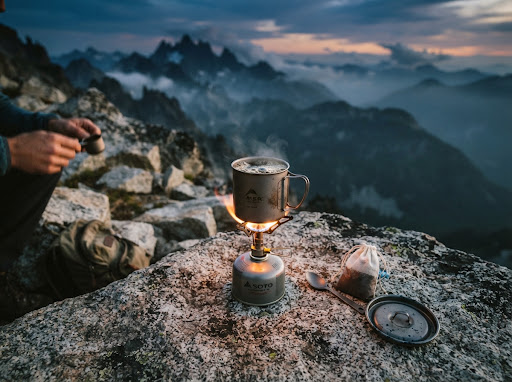Camp kitchen titanium stove at dusk